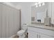 Bathroom featuring granite countertop vanity and shower with tiled walls and curtain at 2081 Gardenia Ave, Port Charlotte, FL 33953