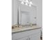 Bathroom vanity with granite countertop and a large mirror, offering a clean design at 2081 Gardenia Ave, Port Charlotte, FL 33953