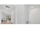 Bright hallway featuring tile floors and white walls, leading to the living area at 2081 Gardenia Ave, Port Charlotte, FL 33953