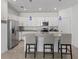 Bright, open kitchen featuring white cabinetry, stainless steel appliances, and a granite island with seating at 2081 Gardenia Ave, Port Charlotte, FL 33953
