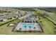 Aerial view of community pool, clubhouse, and tennis courts at 2081 Gardenia Ave, Port Charlotte, FL 33953