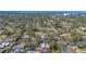 Aerial view of the home nestled among lush trees in an established neighborhood near the water at 2377 Burton Ln, Sarasota, FL 34239