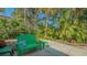 Picturesque backyard featuring a curved walkway lined with lush tropical foliage and trees at 2377 Burton Ln, Sarasota, FL 34239