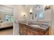 Bathroom showcasing double sinks, decorative mirrors, and access to the bedroom at 2377 Burton Ln, Sarasota, FL 34239