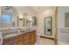 Spacious bathroom featuring a double vanity with a marble countertop and decorative mirrors at 2377 Burton Ln, Sarasota, FL 34239