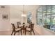 Light-filled breakfast nook featuring woven chairs, glass table, and bright views of the outdoors at 2377 Burton Ln, Sarasota, FL 34239