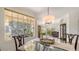 Bright dining room showcasing a glass-top table, elegant chairs, and a large window with outdoor views at 2377 Burton Ln, Sarasota, FL 34239