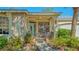 Inviting home entrance with a light-blue door, decorative metal gate, and lush landscaping at 2377 Burton Ln, Sarasota, FL 34239