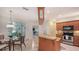 Cozy kitchen and breakfast nook with a stainless steel oven, wooden cabinets, and plenty of natural light at 2377 Burton Ln, Sarasota, FL 34239