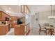 Spacious kitchen area with granite counters, wooden cabinets, and an adjacent breakfast nook at 2377 Burton Ln, Sarasota, FL 34239