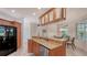 Well-lit kitchen area featuring granite countertops, stainless steel appliances, and a breakfast bar at 2377 Burton Ln, Sarasota, FL 34239