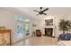 Comfortable living room featuring a fireplace, ceiling fan, tile flooring, and access to an outdoor patio at 2377 Burton Ln, Sarasota, FL 34239
