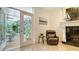 Cozy living room with marble fireplace, comfortable seating, and access to the sunroom at 2377 Burton Ln, Sarasota, FL 34239