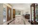 Stylish living room featuring tiled floors, a decorative cabinet, and a comfortable seating area by a bright window at 2377 Burton Ln, Sarasota, FL 34239
