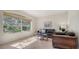Cozy living room offering comfortable seating, tiled floors, and natural light from a large window at 2377 Burton Ln, Sarasota, FL 34239