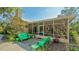 Relaxing screened patio featuring comfortable seating amidst lush greenery and natural sunlight at 2377 Burton Ln, Sarasota, FL 34239