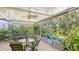 Inviting sunroom with comfortable seating, ceiling fan, and lush green views at 2377 Burton Ln, Sarasota, FL 34239