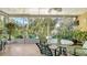 Relaxing sunroom featuring tile flooring, ceiling fan, and views of tropical foliage at 2377 Burton Ln, Sarasota, FL 34239