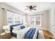 Sunlit main bedroom with hardwood floors, ceiling fan, and multiple windows for ample natural light at 2524 11Th W Ave, Bradenton, FL 34205