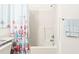 Standard bathroom with a shower-tub combo, grab bar, and a decorative starfish-themed shower curtain at 3300 Loveland Blvd # 3203, Punta Gorda, FL 33980