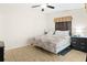 Main bedroom features a king bed, ceiling fan and neutral tile flooring at 3300 Loveland Blvd # 3203, Punta Gorda, FL 33980