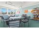 Community clubhouse with tables, chairs, and a bookshelf, perfect for gatherings and relaxation at 3300 Loveland Blvd # 3203, Punta Gorda, FL 33980