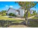 Charming single-story home with light blue siding, a well-maintained lawn, and mature landscaping at 3300 Loveland Blvd # 3203, Punta Gorda, FL 33980
