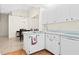 Bright kitchen featuring white cabinetry, tile flooring, and modern appliances at 3300 Loveland Blvd # 3203, Punta Gorda, FL 33980