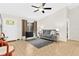 The living room features neutral tile flooring, ceiling fan, and a comfortable gray sofa at 3300 Loveland Blvd # 3203, Punta Gorda, FL 33980