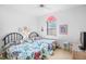 Bright bedroom with two twin beds, floral bedding, and a large window providing natural light at 3370 E Chelmsford Ct # 49, Sarasota, FL 34235