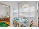 Bright breakfast nook with a glass-top table and wicker chairs, offering a cozy dining space near the kitchen at 3370 E Chelmsford Ct # 49, Sarasota, FL 34235