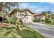 A single-Gathering home featuring a clay tile roof and well-maintained landscaping at 3370 E Chelmsford Ct # 49, Sarasota, FL 34235