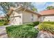 Charming home featuring a red tile roof, a meticulously manicured yard, and an attached garage at 3370 E Chelmsford Ct # 49, Sarasota, FL 34235