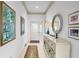 Bright foyer featuring neutral paint, tile flooring, decorative accents, and a stylish console table at 3370 E Chelmsford Ct # 49, Sarasota, FL 34235