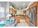 Bright kitchen with stainless steel appliances, tile floors, and wood cabinets, open to the dining area at 3370 E Chelmsford Ct # 49, Sarasota, FL 34235