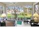 Relaxing sunroom with comfortable seating and a beautiful view of the lush backyard at 3370 E Chelmsford Ct # 49, Sarasota, FL 34235