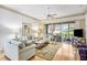 This bright living room has a large glass sliding door and comfortable furniture at 3370 E Chelmsford Ct # 49, Sarasota, FL 34235