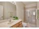 Bathroom with tile floor, wood vanity, and shower with glass doors for a clean look at 3823 Parkridge Cir # 1-101, Sarasota, FL 34243