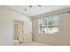 Carpeted bedroom featuring natural light from the large window and a view to the patio at 3823 Parkridge Cir # 1-101, Sarasota, FL 34243