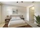 Cozy bedroom with a queen bed, side tables, lamps, and natural light, creating a peaceful retreat at 3823 Parkridge Cir # 1-101, Sarasota, FL 34243