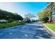 Gated community entrance with lush landscaping, and an American flag at 3823 Parkridge Cir # 1-101, Sarasota, FL 34243