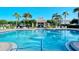 Stunning community pool with a cabana, seating, and lush landscaping at 3823 Parkridge Cir # 1-101, Sarasota, FL 34243