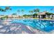Gorgeous community pool area with palm trees, a cabana, and comfortable lounge chairs at 3823 Parkridge Cir # 1-101, Sarasota, FL 34243