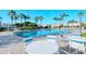 Inviting community pool area with tables, chairs, and lounge seating at 3823 Parkridge Cir # 1-101, Sarasota, FL 34243