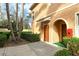 Close up of a home's entrance, showcasing an arched doorway with a quaint covered entry at 3823 Parkridge Cir # 1-101, Sarasota, FL 34243