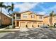 Charming townhome with three garage spaces, stucco facade, and tropical landscaping with palm trees at 3823 Parkridge Cir # 1-101, Sarasota, FL 34243