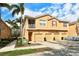 Attractive townhome featuring a stucco facade, three garages, and tropical palm tree landscaping at 3823 Parkridge Cir # 1-101, Sarasota, FL 34243