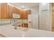 Bright kitchen features wooden cabinets, white appliances and countertops, and a modern faucet at 3823 Parkridge Cir # 1-101, Sarasota, FL 34243