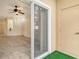View of the living room through glass doors highlighting wood-look floors and a ceiling fan at 3823 Parkridge Cir # 1-101, Sarasota, FL 34243