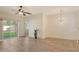 Bright, open living room featuring modern floors, ceiling fan, and a sliding door to the outside at 3823 Parkridge Cir # 1-101, Sarasota, FL 34243